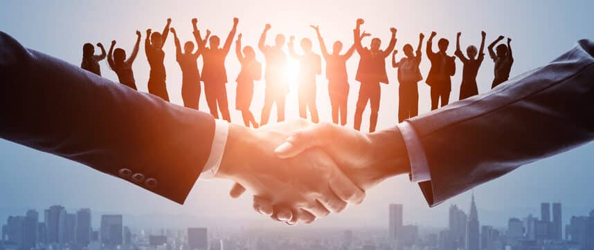 Hand Shake | People in office suits cheering on background | TemPositions Q&A | TemPositions Staffing Agency
